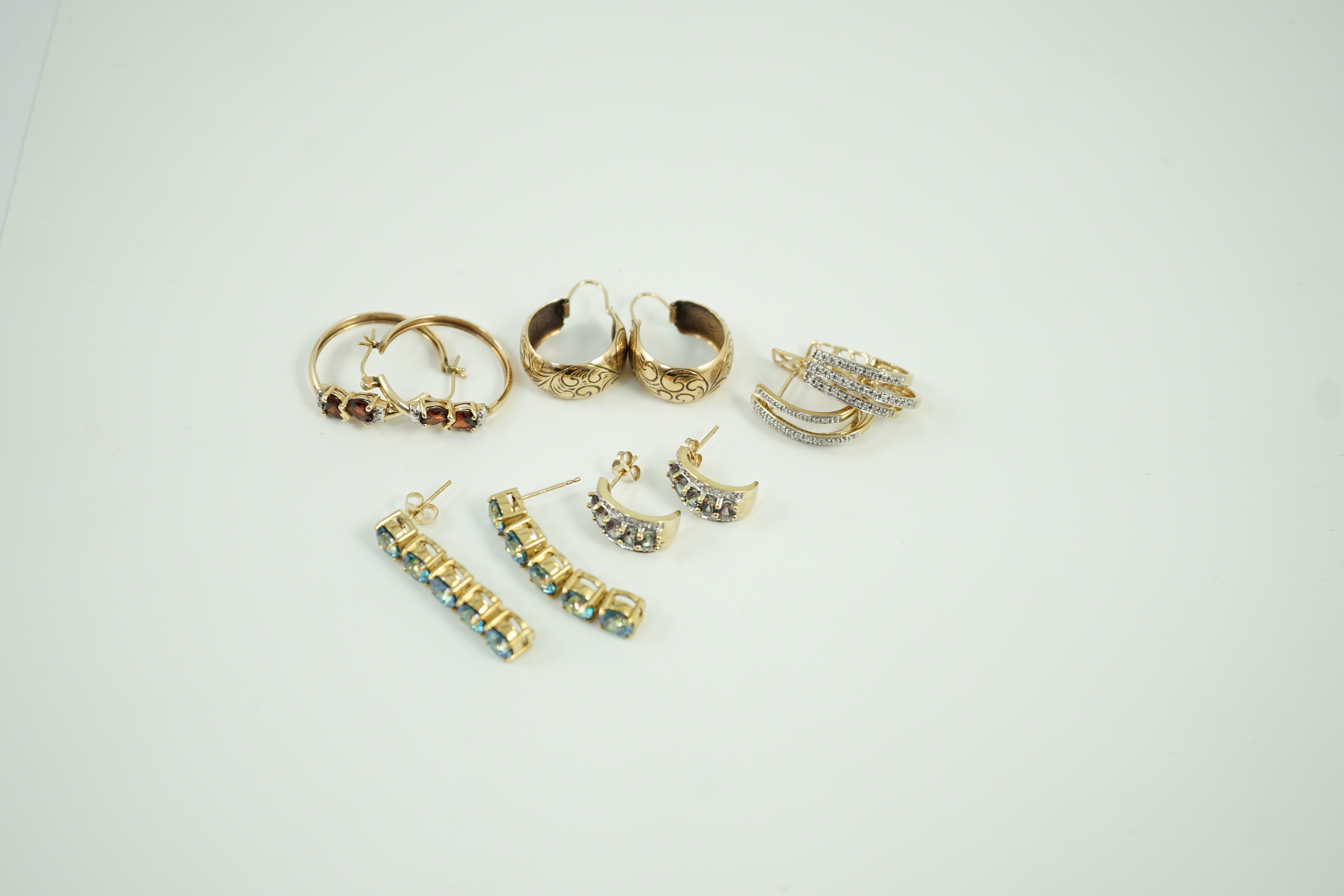 Four assorted modern pairs of 9ct gold and gem set earrings and one pair of yellow metal earrings, gross weight, 23.2 grams.